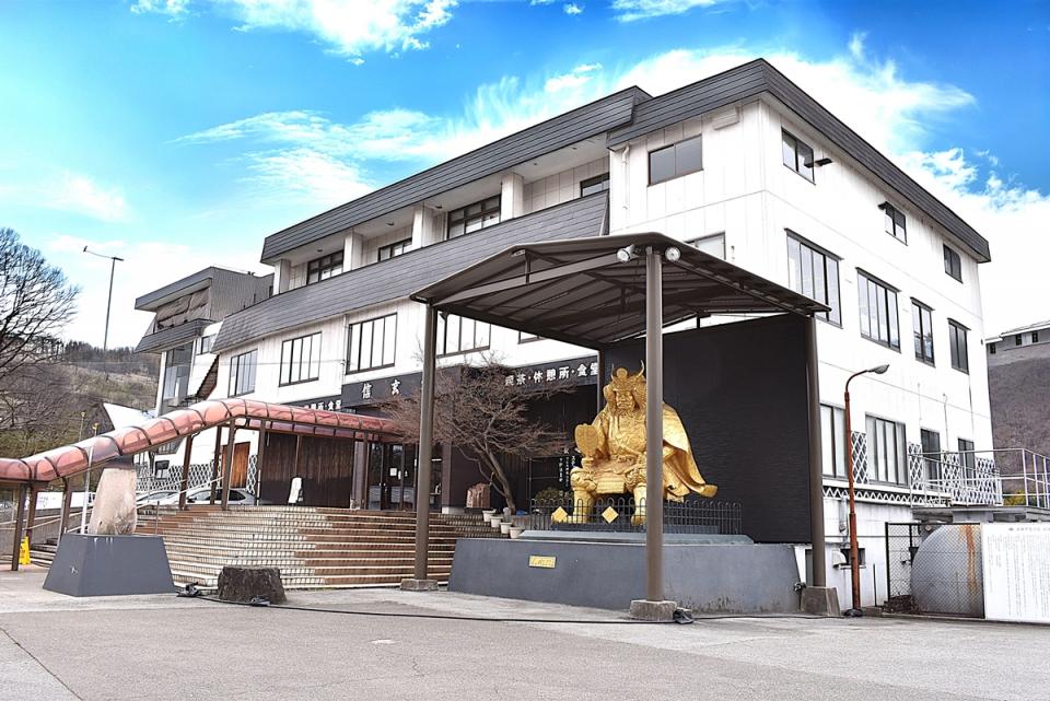 建物の前に黄金の信玄公像がそびえるパワースポット